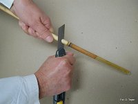 Cutting reed stems into red mason bee nesting tubes